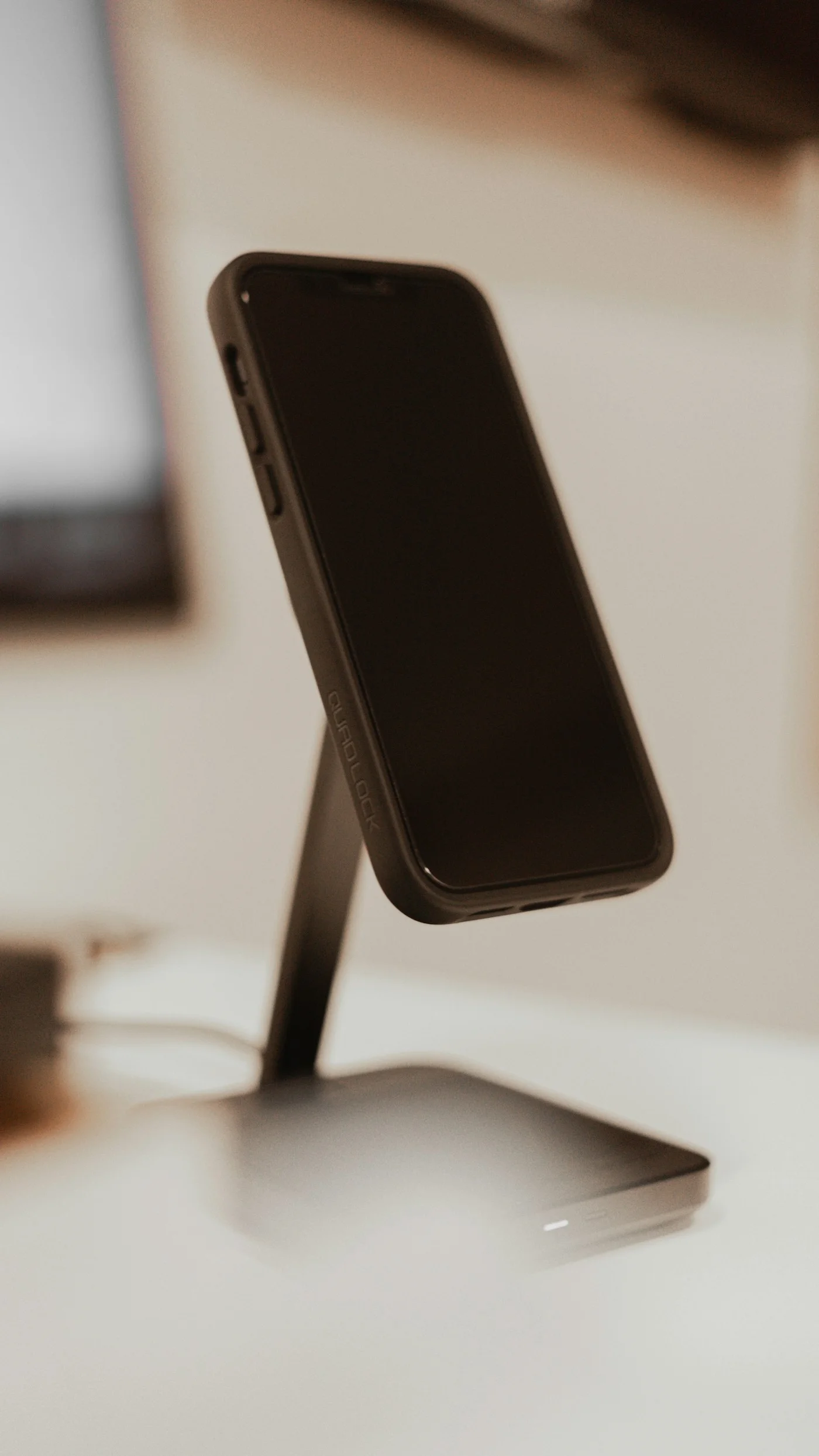 Smartphone resting on a desk stand